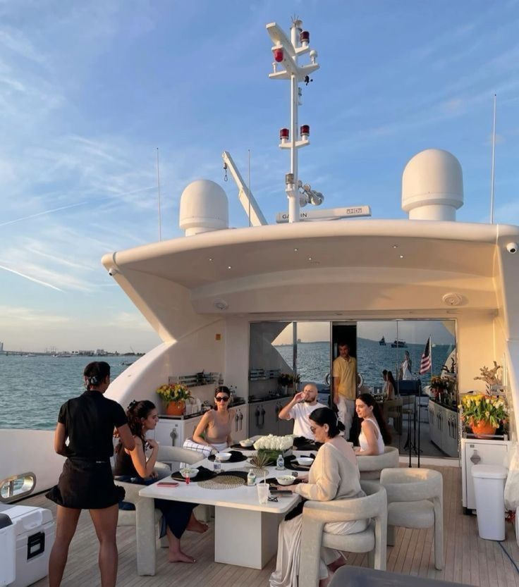 People dining together on a yacht deck table